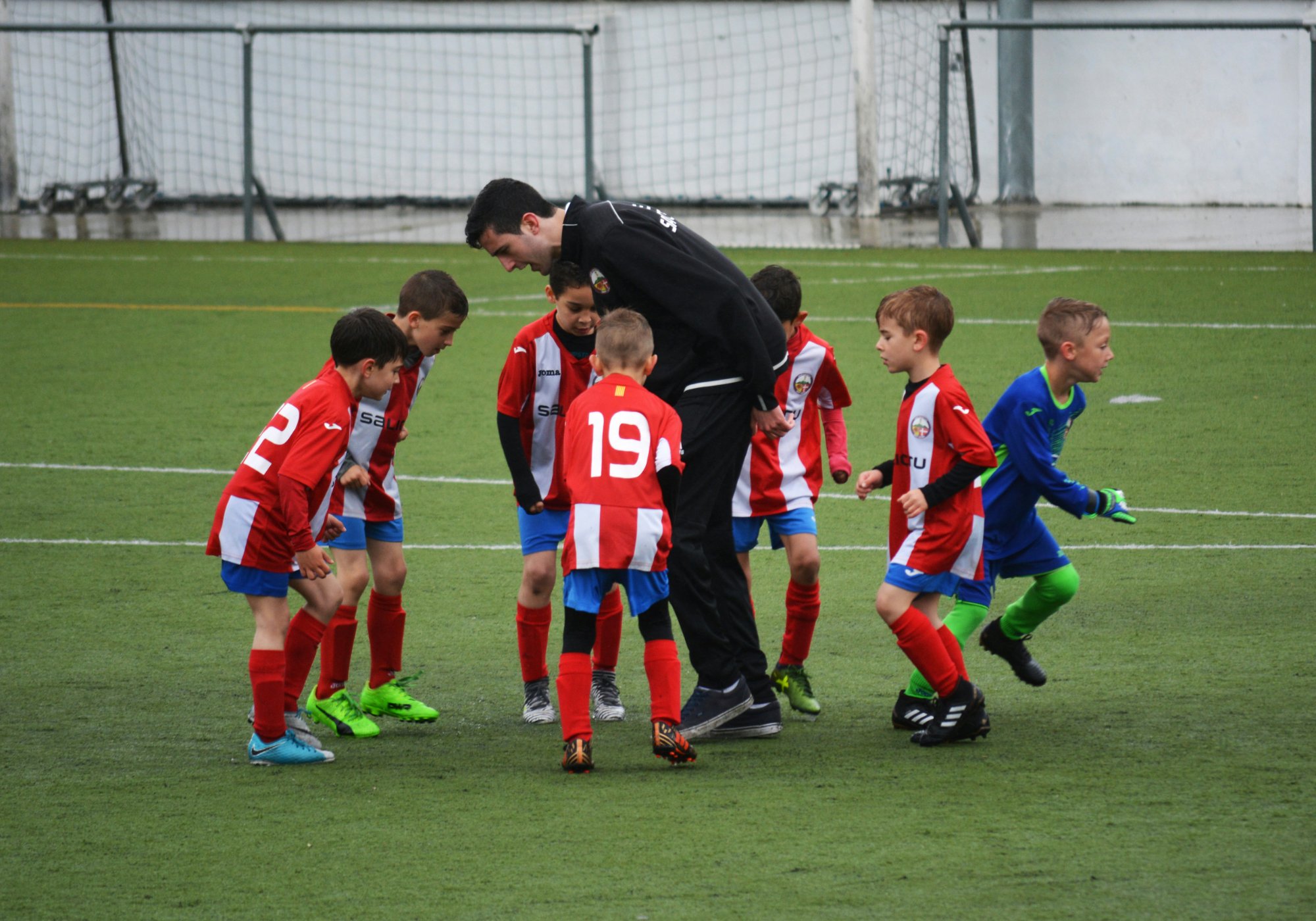 Grassroots football coach with players